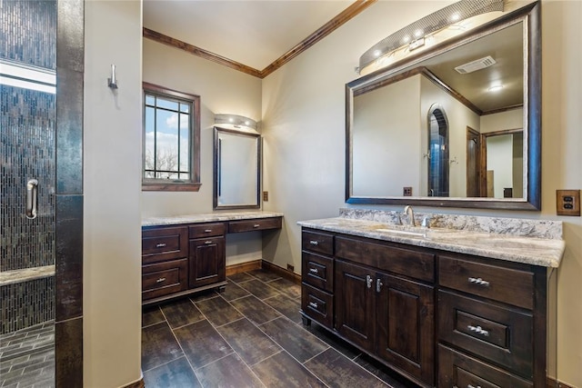 bathroom featuring vanity, a shower with shower door, and ornamental molding