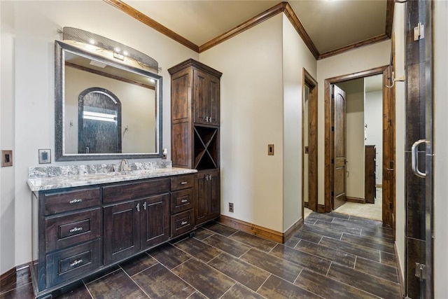 bathroom with crown molding and vanity