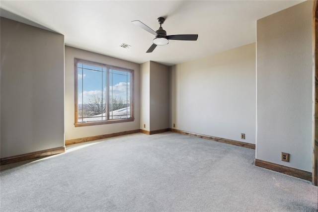 spare room featuring ceiling fan and light carpet