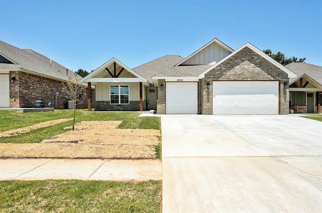 craftsman inspired home featuring a garage and a front yard