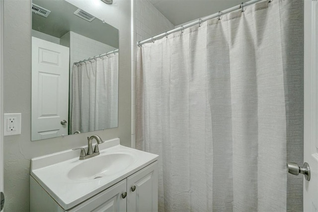 bathroom featuring vanity and a shower with shower curtain