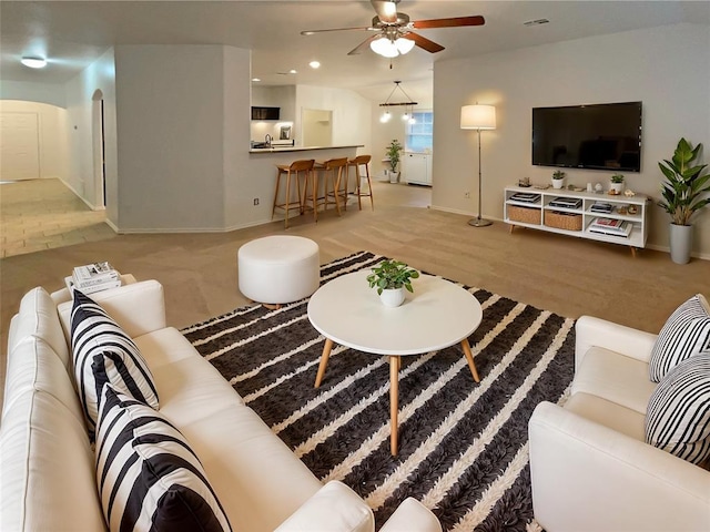 living room with ceiling fan and vaulted ceiling