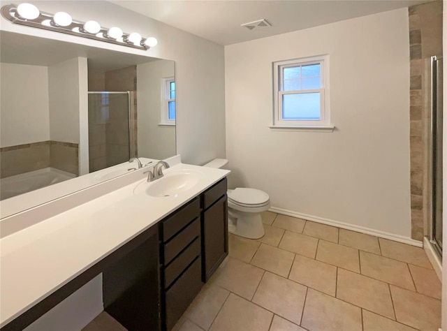 full bathroom with toilet, vanity, plus walk in shower, and tile patterned flooring