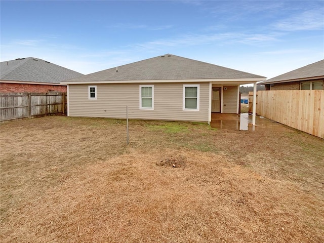 back of house with a lawn