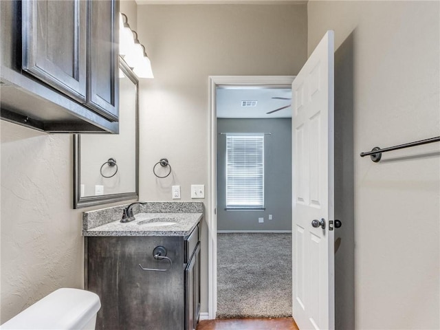 bathroom with vanity and toilet