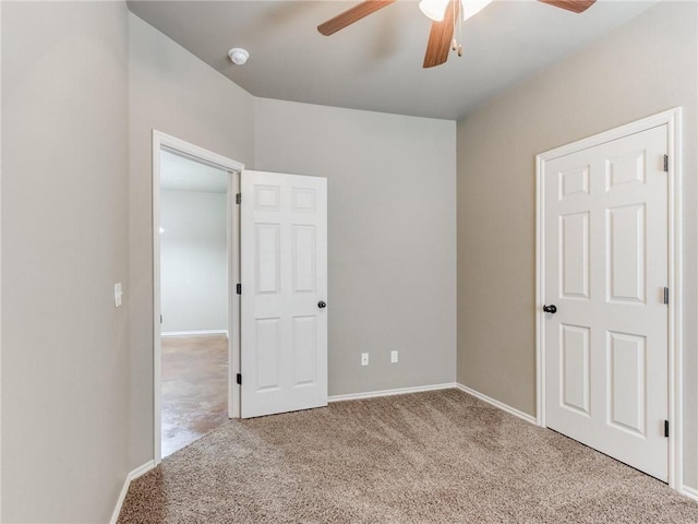 unfurnished bedroom featuring ceiling fan and light carpet