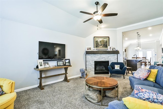 carpeted living room featuring vaulted ceiling, sink, ceiling fan, and a fireplace