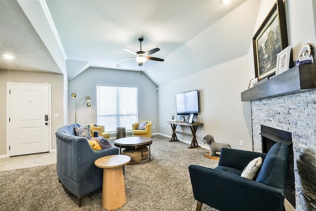 living room featuring ceiling fan, a stone fireplace, vaulted ceiling, and light carpet