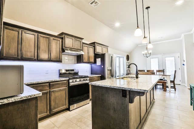 kitchen with sink, light stone counters, hanging light fixtures, a center island with sink, and appliances with stainless steel finishes