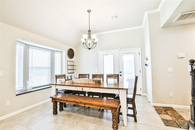 dining space with crown molding, lofted ceiling, light tile patterned floors, and a chandelier