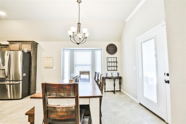 dining room featuring lofted ceiling and a notable chandelier