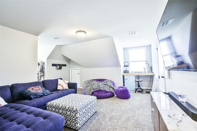 carpeted living room with lofted ceiling