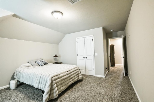 bedroom with lofted ceiling, carpet floors, and a closet