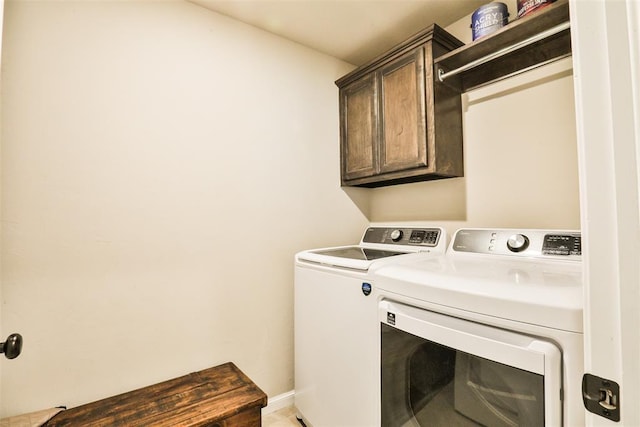 laundry area with cabinets and separate washer and dryer