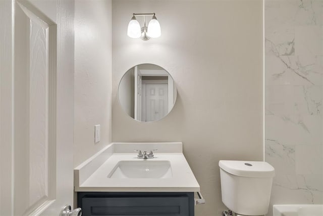 bathroom featuring vanity, walk in shower, and toilet