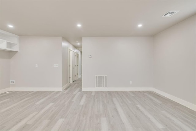 empty room with light hardwood / wood-style flooring