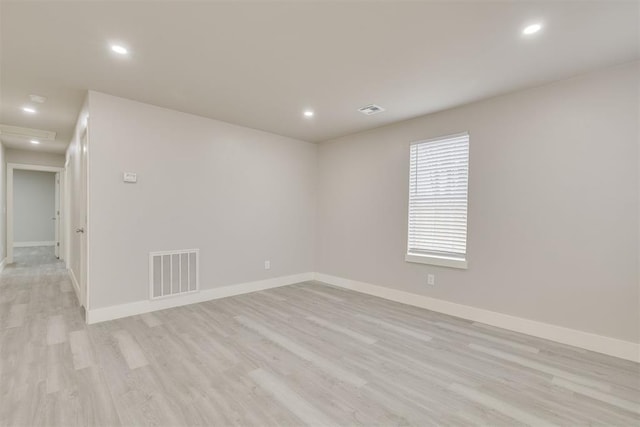 unfurnished room with light hardwood / wood-style floors