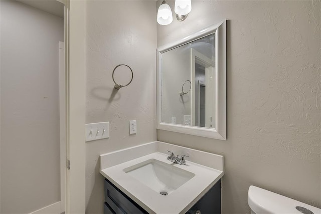 bathroom with vanity and toilet