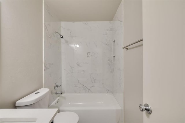 full bathroom with vanity, tiled shower / bath combo, and toilet