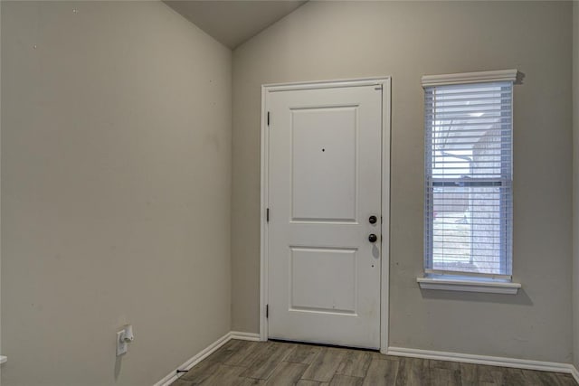 doorway to outside with hardwood / wood-style flooring and lofted ceiling