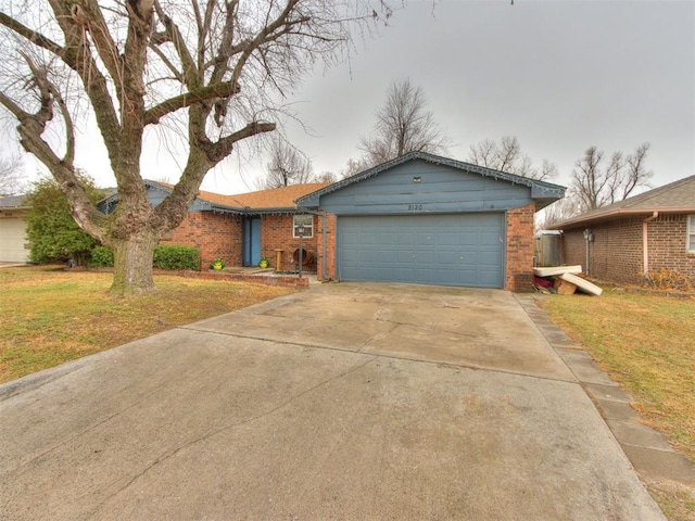 ranch-style home featuring a garage and a front yard