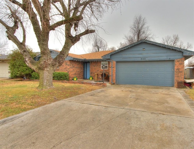 single story home featuring a garage and a front lawn