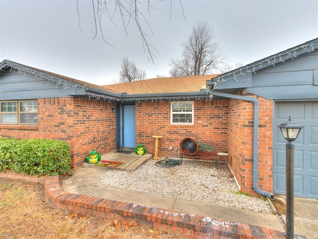 doorway to property with a garage