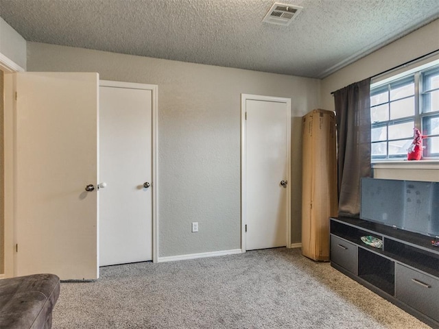 carpeted bedroom with a textured ceiling