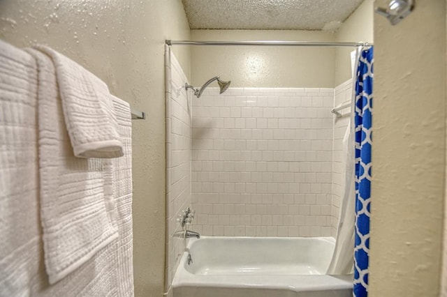 bathroom featuring a textured ceiling and shower / bath combo