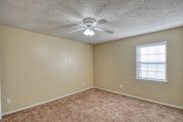 empty room featuring baseboards, ceiling fan, a textured ceiling, and carpet