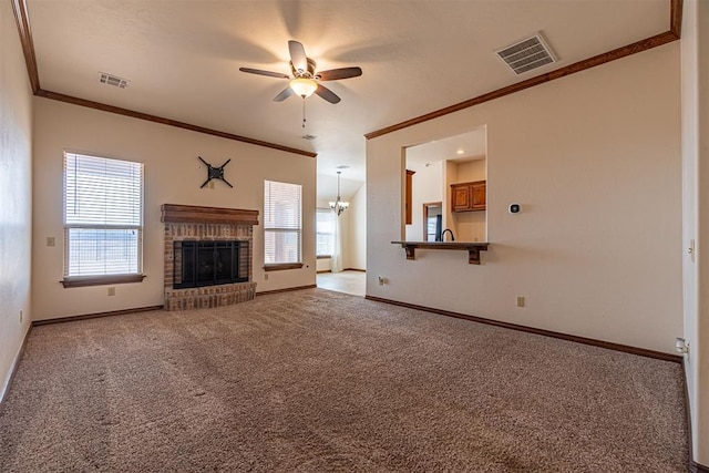 unfurnished living room featuring light carpet, a brick fireplace, crown molding, and plenty of natural light