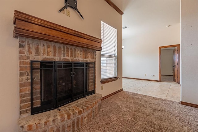 unfurnished living room with a brick fireplace and light tile patterned floors