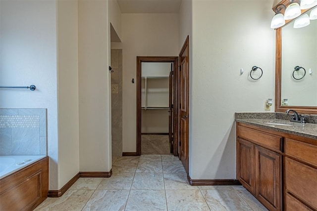 bathroom with vanity, a bathtub, and tile patterned floors