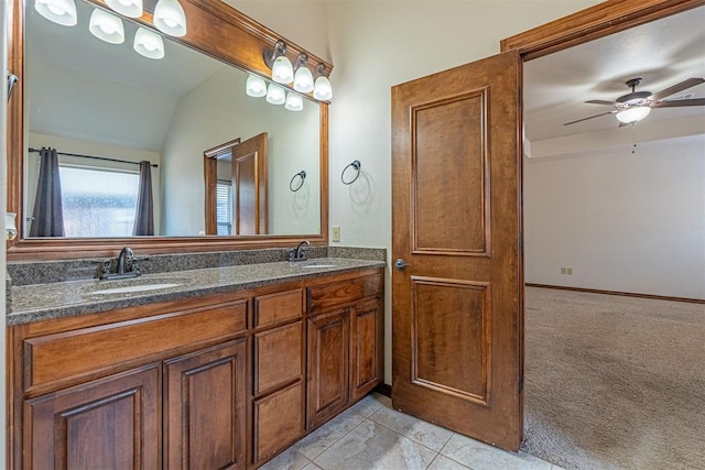 bathroom featuring vanity, tile patterned flooring, vaulted ceiling, and ceiling fan