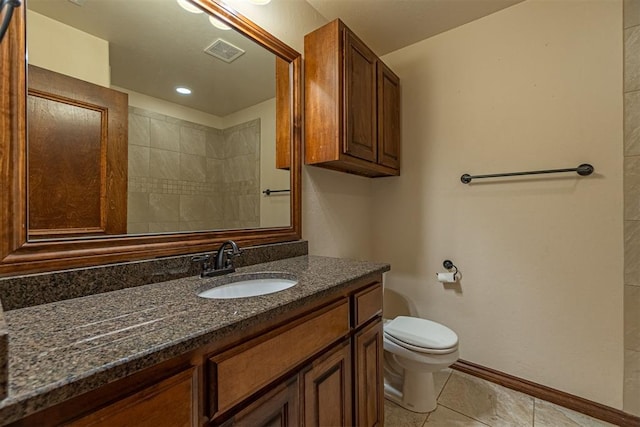 bathroom featuring tile patterned flooring, vanity, and toilet