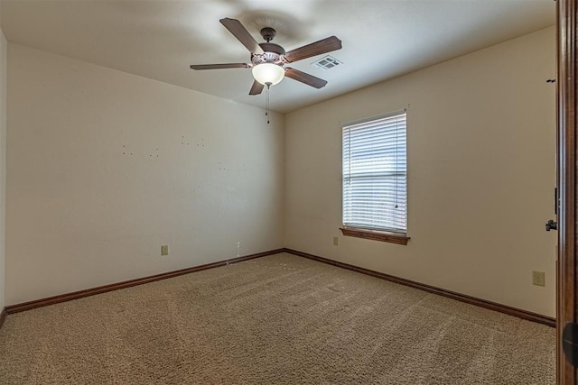 carpeted spare room with ceiling fan