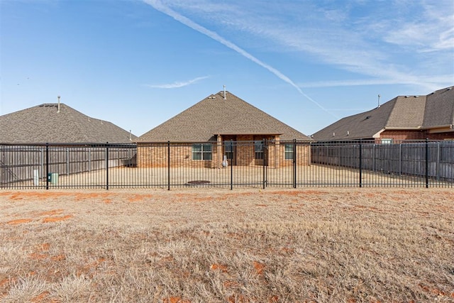 rear view of house featuring a yard