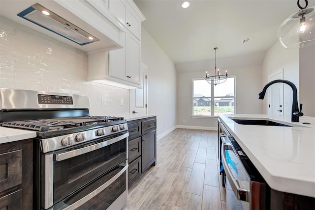 kitchen with white cabinetry, dishwasher, sink, range with two ovens, and custom range hood