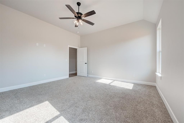 carpeted spare room with ceiling fan and lofted ceiling