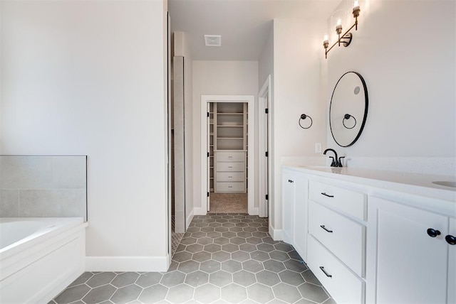 bathroom with tile patterned floors, vanity, and a bathtub