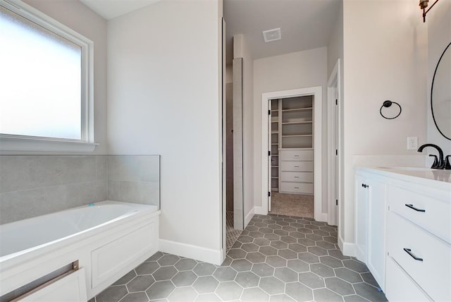 bathroom with vanity and a tub