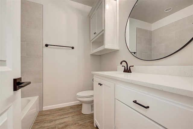 full bathroom featuring vanity, hardwood / wood-style flooring, toilet, and shower / bath combination