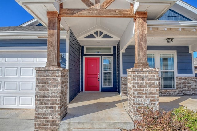 doorway to property with a garage