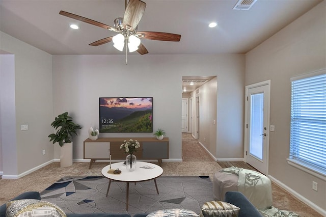 carpeted living room featuring ceiling fan