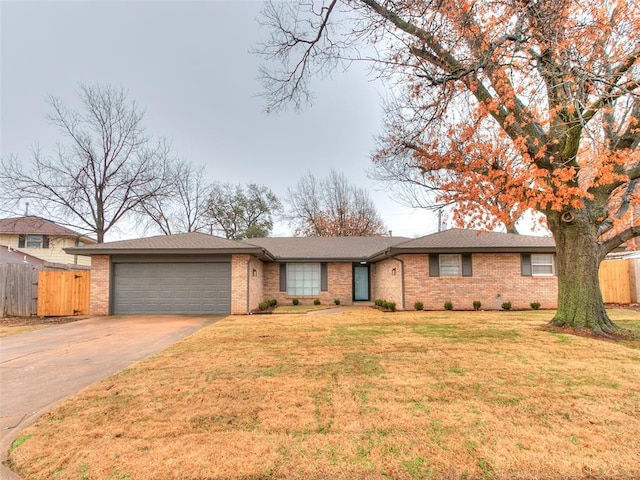 ranch-style house featuring a garage and a front lawn