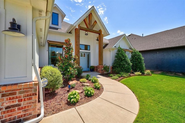 doorway to property featuring a lawn