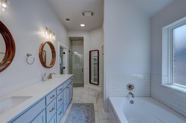 bathroom with vanity and independent shower and bath