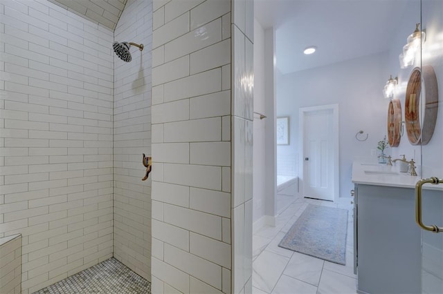 bathroom with vanity and shower with separate bathtub