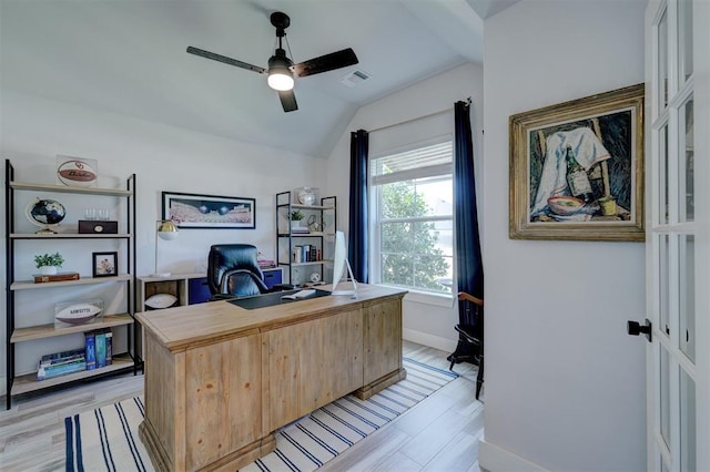 home office with ceiling fan, light hardwood / wood-style floors, and vaulted ceiling