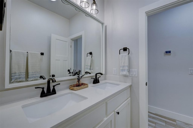 bathroom featuring hardwood / wood-style flooring and vanity